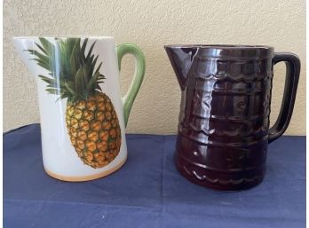 A Grouping Of Two Pitchers Including A Pineapple Pitcher