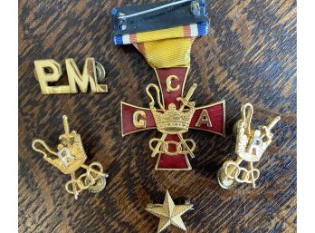 A Collection Of Carved Military Pins