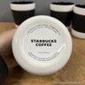 Set Of Four Starbucks Black And White Coffee Mugs With Silicone Grip Ring Around Center