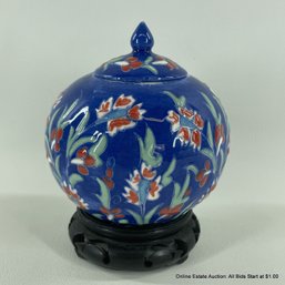 Porcelain Lidded Jar On Wood Stand Orange Flowers On A Blue Background