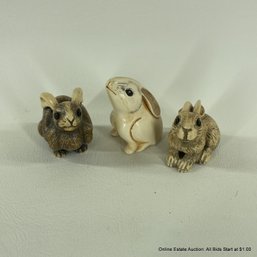 Three Carved Resin Bunny Figurines