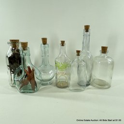 7 Assorted Glass Bottles With Cork Stoppers