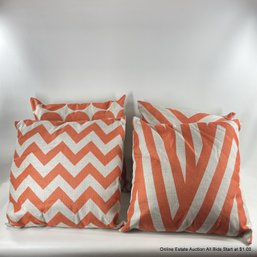 4 Throw Pillows With Orange Geometric Designs
