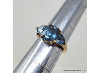 10K Yellow Gold Ring Features One (1) Cushion And Two (2) Triangular London Blue Topaz.