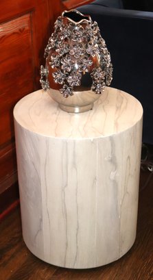 Light Wood Cylinder Shaped Side Table & Shiny Silver Ceramic Vase With Appliqued Flowers