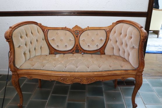Highly Carved Victorian Style Love Seat With Tufted Velvet Upholstery.