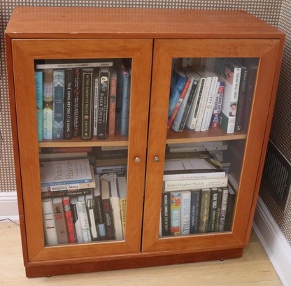 A Maple Bookcase Cabinet With Glass Doors And 1 Shelf.