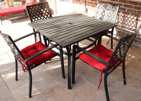 Outdoor Square Aluminum Table And Four Arm Chairs With Red Cushions.