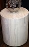 Light Wood Cylinder Shaped Side Table & Shiny Silver Ceramic Vase With Appliqued Flowers
