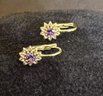 14K YG Pair Of Dainty Flower Earring With Amethyst Center Stone.