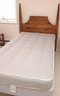 A Shaker Style Poster Twin Headboard With Shiffman Mattress And Box Spring.
