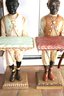 Pair Of Vintage Blackamoors In Colorful Apparel And Holding Pillows