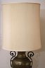 Tall Brass Urn Shaped Lamp With Handles On A Wood Base