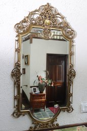 Antique Rococo Style Brass Framed Beveled Mirror With Florentine Flourish.