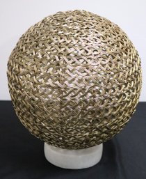 Gold Braided Metal Orb On White Marble Base
