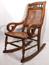 Antique Child Sized Carved Wood Lincoln Rocking Chair With Caned Seating And Backrest