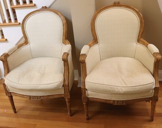 Pair Of Louis XVI Style Carved Light Wood Bergere Chairs With Cream Color Upholstery.