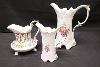 Three Royal Danube White Porcelain Pitchers With Painted Flowers.