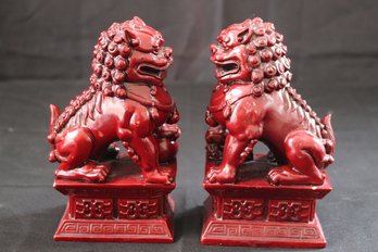 Pair Of Deep Burgundy Colored Resin Foo Dogs With Great Details.