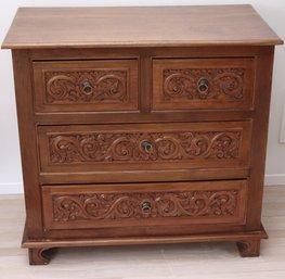 A Highly Carved Hardwood Chest Of Drawers With Foliate Scrolls On The Drawers And Sides.