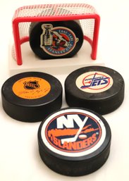 A Commemorative Stanley Cup Puck (1893-1992) In Net And 3 Additional Pucks.