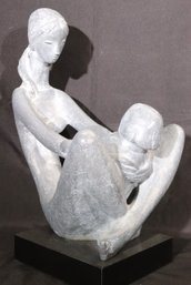 Austin Products Grey Plaster Statue Of Mother And Child On A Black Plexiglass Base.