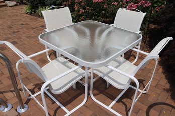 Textured Glass Outdoor Table With White Metal Frame And Four Armchairs