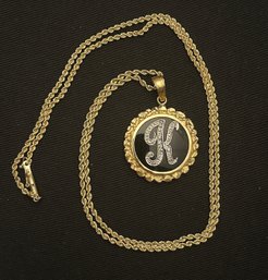 14K 24 INCH FINE ROPE CHAIN WITH DIAMOND K INITIAL PENDANT ON AN ONYX BACKGROUND