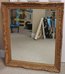 Carved Light Wood Framed Mirror With Some Separation At Corners.