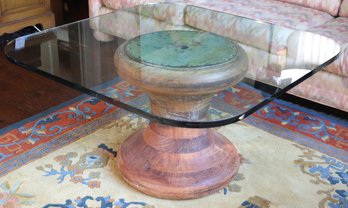 Table With  Thick Glass Top With Rounded Edges On A Turned Wood Base