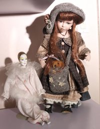 Two Vintage Dolls With A Harlequin And A Bisque Head Doll With Petticoat
