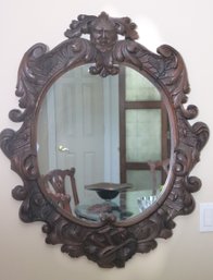 Carved Wooden Oval Mirror Frame With The North Wind And Musical Instruments.