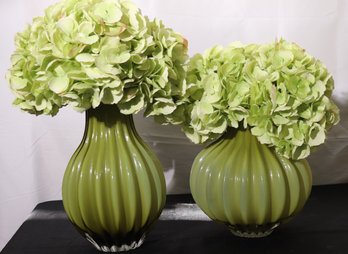 Two Moss Green Glass Vases With Contemporary Ribbed Exterior And Silk Hydrangeas.