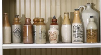 Large Lot Of Stoneware Bottles With Lids.