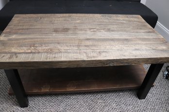 Rustic Style Wooden Coffee Table With Black Metal Legs And Lower Shelf.