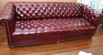 Fine Chesterfield Style Tufted Genuine Top Grain Leather Burgundy Sofa With Nail Head Accents Along The Edges
