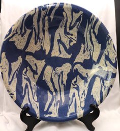 A Large Hand Thrown Art Pottery Bowl With White Swirls On Blue Background.