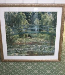 Framed Monet Poster Of Garden With Water Lilies And Bridge.