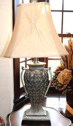 Urn Shaped Table Lamp In Silver Finish With Tan Colored Bell Style Fabric Shade