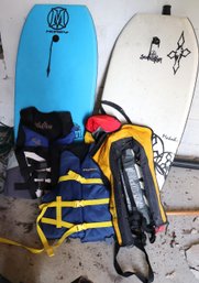 Two Pre-owned Boogie Boards, And 5 Life Jackets.