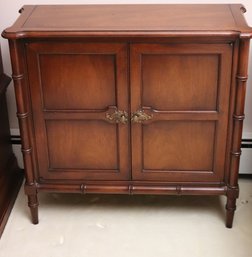 Two Door Mahogany Wood Cabinet With Faux Bamboo Legs.