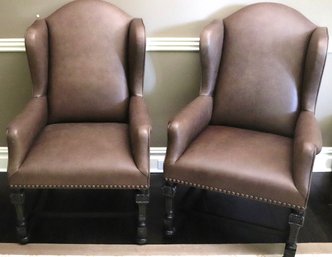 Pair Of Vintage Wood Wingback Arm Chairs With A Custom Contemporary Leather Upholstery And Nail Head Accents