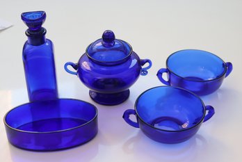 Five Cobalt Blue Glass Items With Handles Cups, Bowl, Covered Sugar &  Bottle