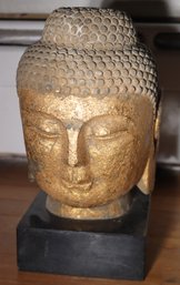 Highly Detailed Gilded Stone Buddha Head On Black Granite Base.