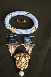 An Assortment Of Vintage Jewelry With Blue Beaded Bracelet, Pin, And Earrings.