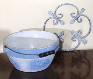 Salt Glazed Ceramic Bowl With Blue Finishes And Handle And Metal Ornament With Fleur De Lys.