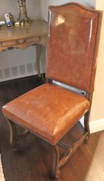 Classic Wood Dining Chair With A Camel Toned Vinyl Finish With Nail Head Accents Along The Edges