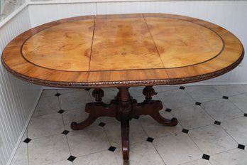 Dining Table With A Leaf Insert That Extends The Table To Oval