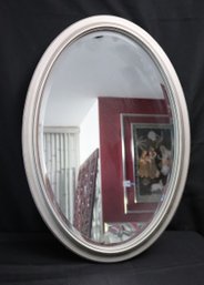 Oval Beveled Mirror In A Silver- Colored Frame