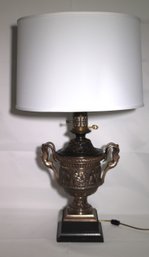 Antique Metal And Brass Table Lamp With Serpent Figural Handles And Embossed Scenery Along The Side